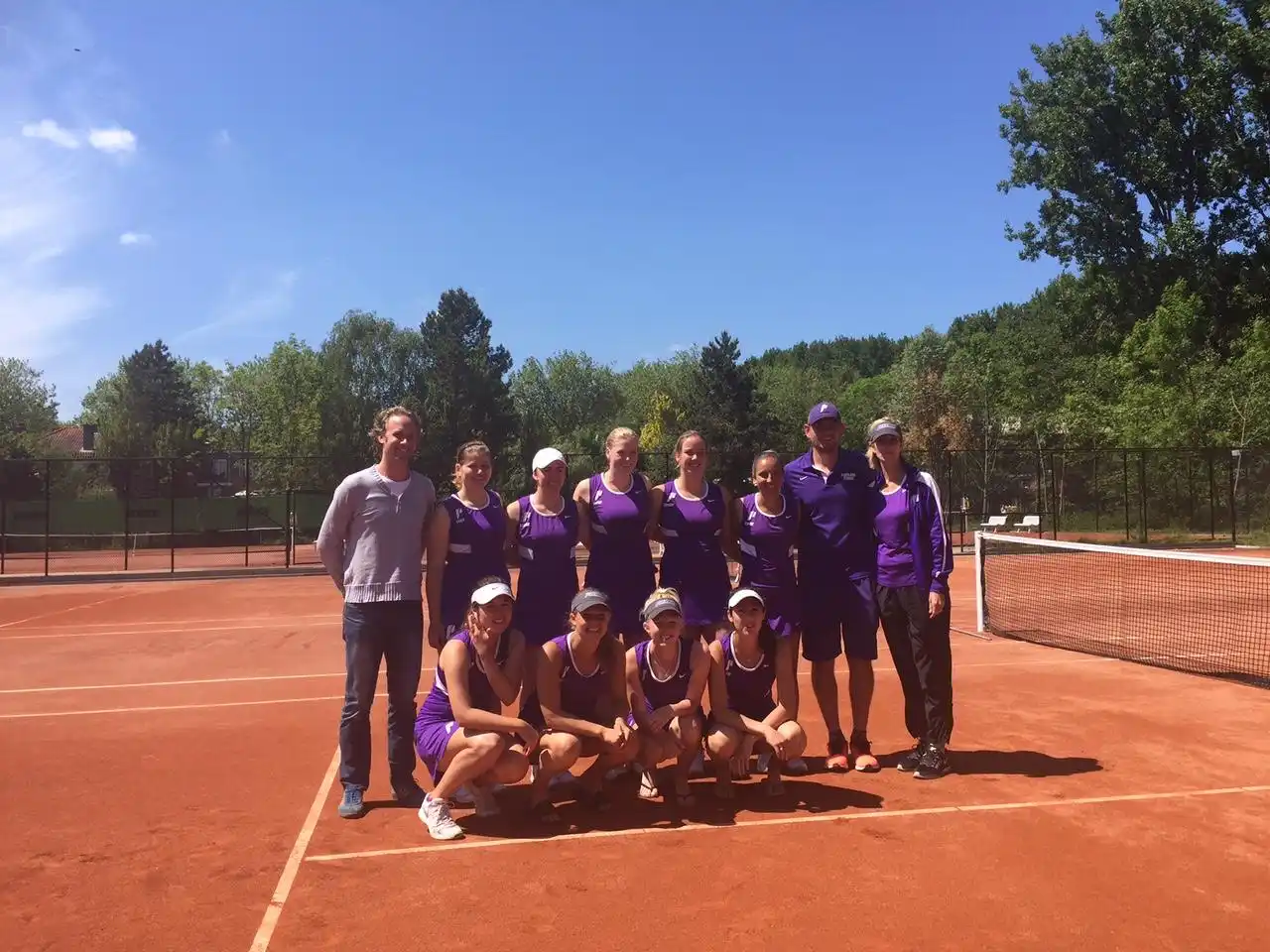 International tennis camp group at NTC Amstelveen — USA college team on clay court